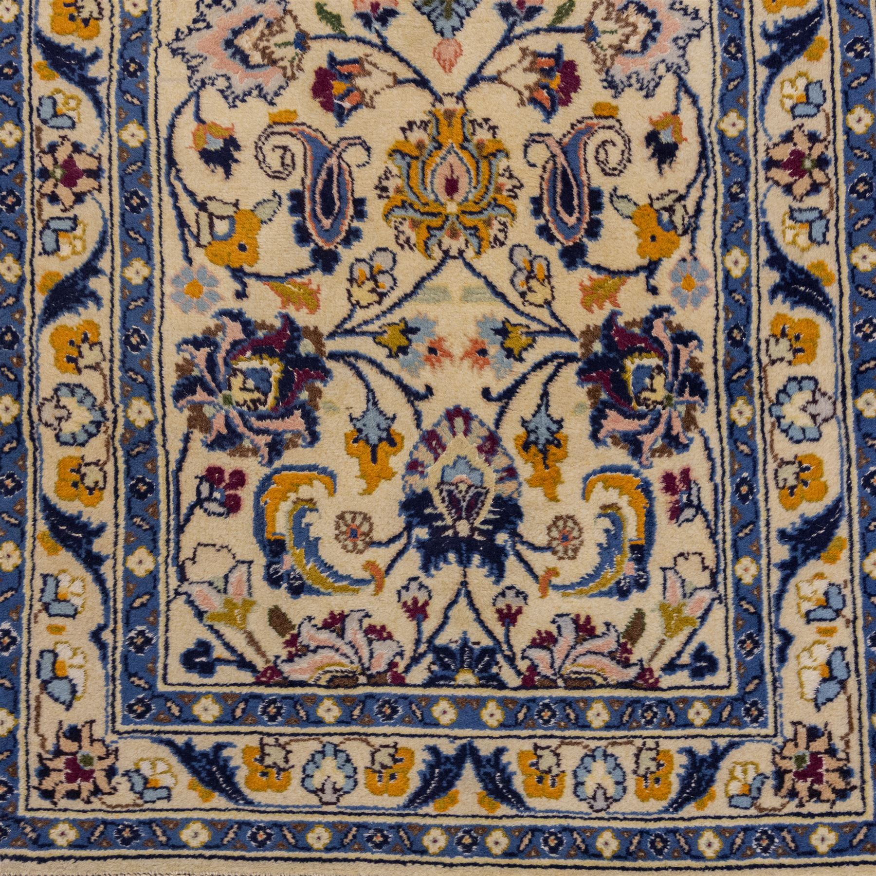 Central Persian Kashan hand-knotted runner, ivory field decorated with an elegant all-over scrolling vine design composed of finely drawn palmettes, floral strays and arabesques in a continuous lattice, principal border on an indigo ground decorated with palmette and vine scroll, flanked by multiple narrow guard stripes, with cotton fringe ends 