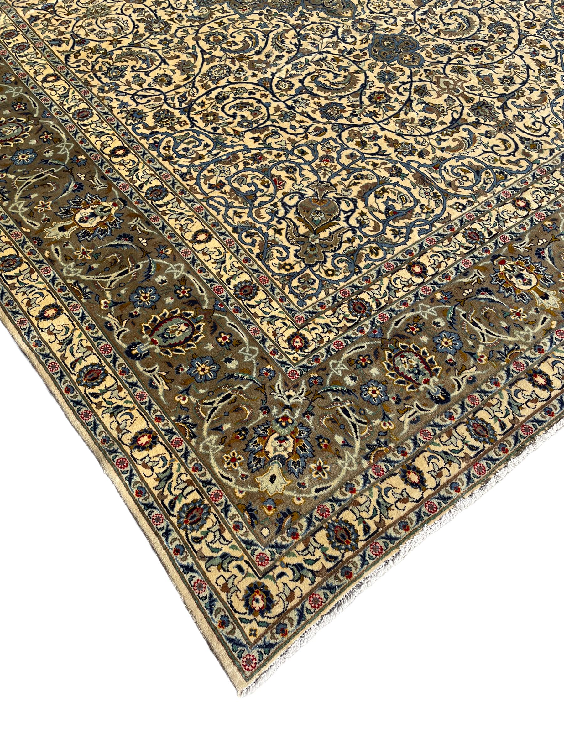 Persian Meshed carpet, ivory ground and decorated with intricate floral design with trailing scrolled branch, the central medallion decorated with stylised plant motifs, seven band border, the main band decorated with scrolls and flower head motifs