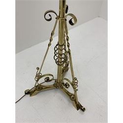 Early 20th century brass standard lamp, telescopic stem with three splayed supports, scroll work to the base, H180cm (max height once fully extended, measurement excludes shade and fitting)
