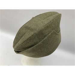 Five reproduction German WW2 hats comprising Wehrmacht olive tropical helmet, Heer officer's peaked cap, two M43 caps and Field side cap (5)