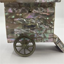 19th century French souvenir jewellery casket in the form of a bathing machine, having mother of pearl panelled tiled effect body, hinged roof/cover revealing a blue silk fitted interior with cushioned base, two silvered metal wheels, abalone shell door and mother of pearl steps, inscribed 'Berck Plage' in blue, H12cm, W13cm 