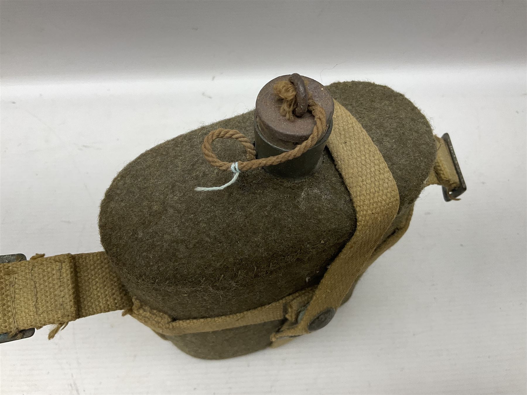 Five military caps/berets comprising two peaked caps with 'Yorkshire' and 'Royal Engineers' badges; maroon beret with parachute regiment badge; red beret with Military Police badge; and AB seaman hat with HM Submarines band; and a felt and webbing covered water bottle (6)