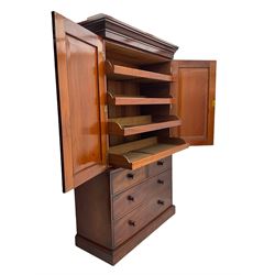 Victorian mahogany linen press, projecting moulded cornice, two doors with arched panels enclosed four linen slides, the lower section fitted with two short and two long drawers, on plinth base