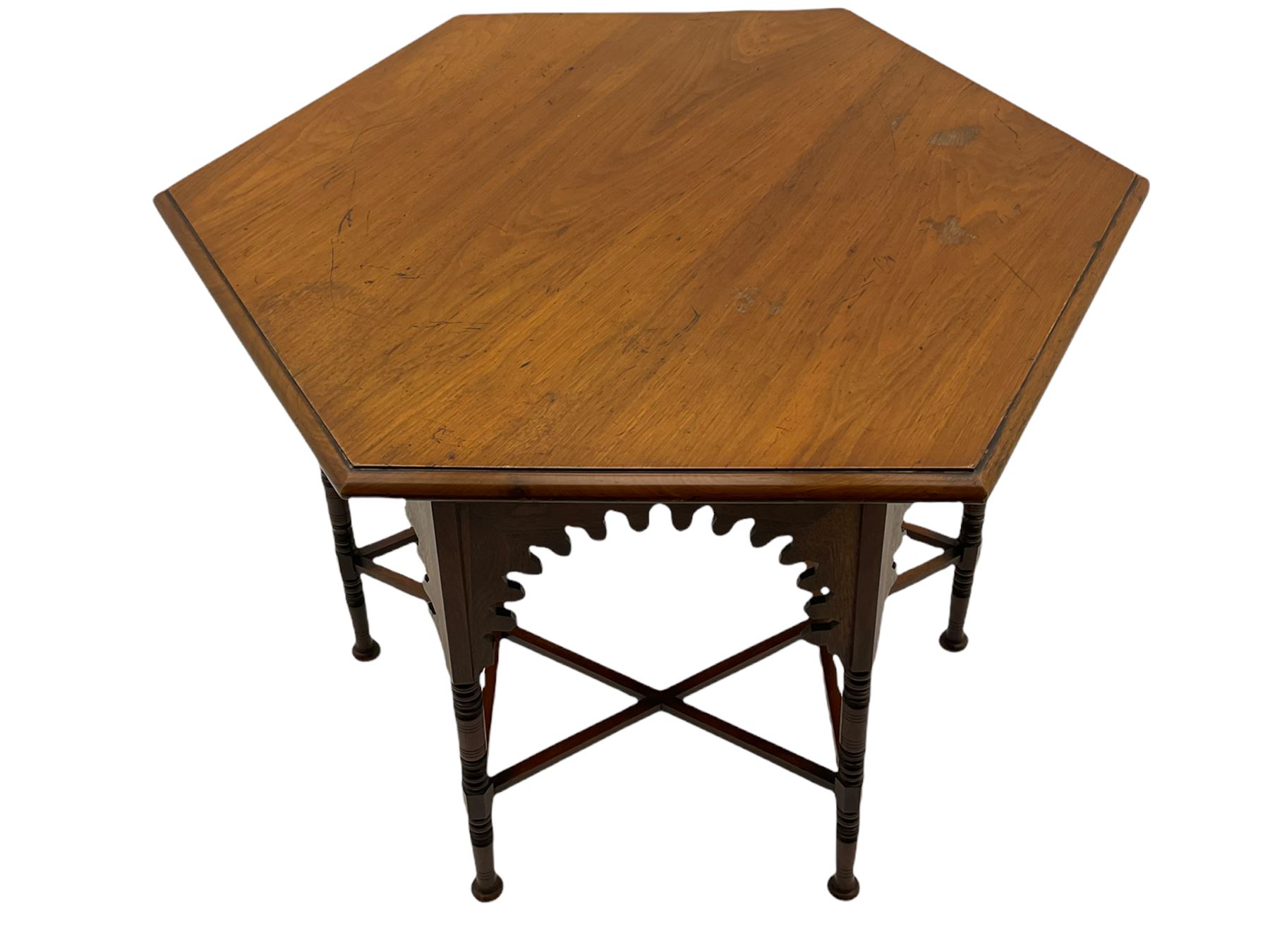 Liberty & Co circa 1890 - walnut centre table, hexagonal form, fretwork frieze, star stretcher base, turned supports on button feet. Stamped on underside.
Featured in - Pictorial Dictionary of British 19th century Furniture Design, Daryl Bennett Liberty's Furniture, 1875-1915, The Birth of Modern Design.
Liberty Style, The Classic Years, 1898 - 1910, by Mervin Levy.
