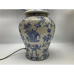 Modern pierced oriental white ceramic vase shaped table lamp, together with a blue and white baluster shaped example decorated with figures upon elephants, both with shades, tallest H83cm incl shade