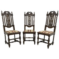 Set of six Victorian Carolean Revival carved oak dining chairs, back pierced and carved with scrolling foliate vines flanked by spiral turned uprights, seat upholstered in striped floral fabric, on barley-twist supports