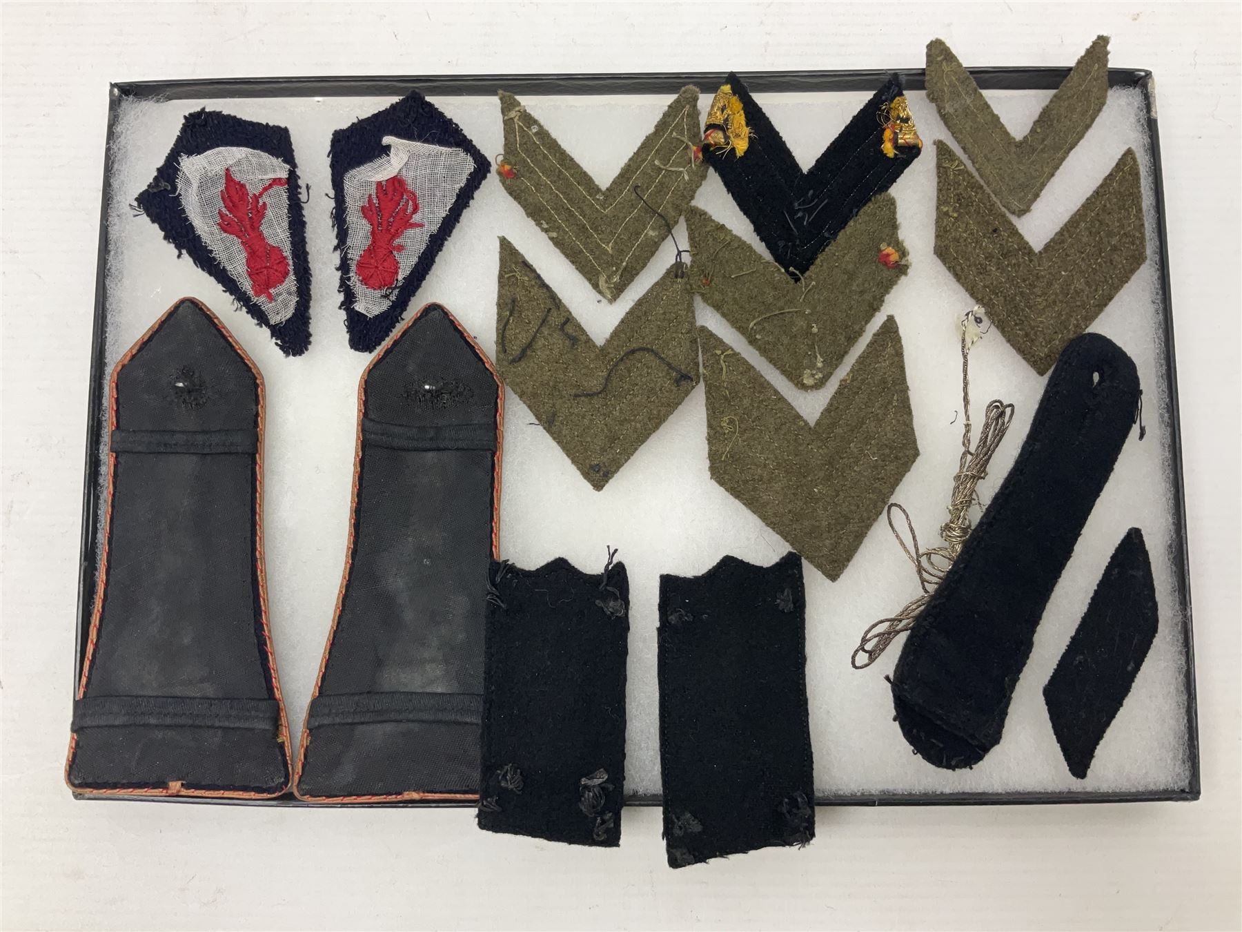 Over thirty items of French Sapeur Pompiers (Fire Service) cloth insignia and buttons c1930s/40s; in small glazed display case