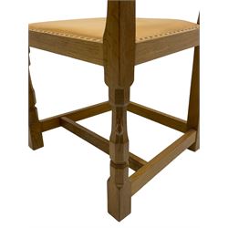 Mouseman - oak carver elbow chair, pierced and carved lattice back over leather upholstered seat with stud band, on octagonal supports united by plain stretchers, carved with mouse signature, by the workshop of Robert Thompson, Kilburn 