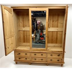Solid pine wardrobe, moulded top above central mirrored panel flanked by two doors above six drawers, turned supports 