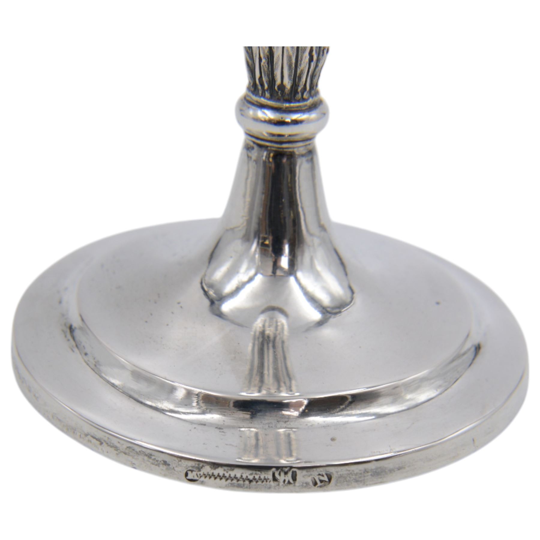 Pair of continental silver candlesticks, probably German Hanau, each of tapering form, with fern leaf decoration, upon a stepped circular base, with Hanau marks and assay scrape to base, H19cm