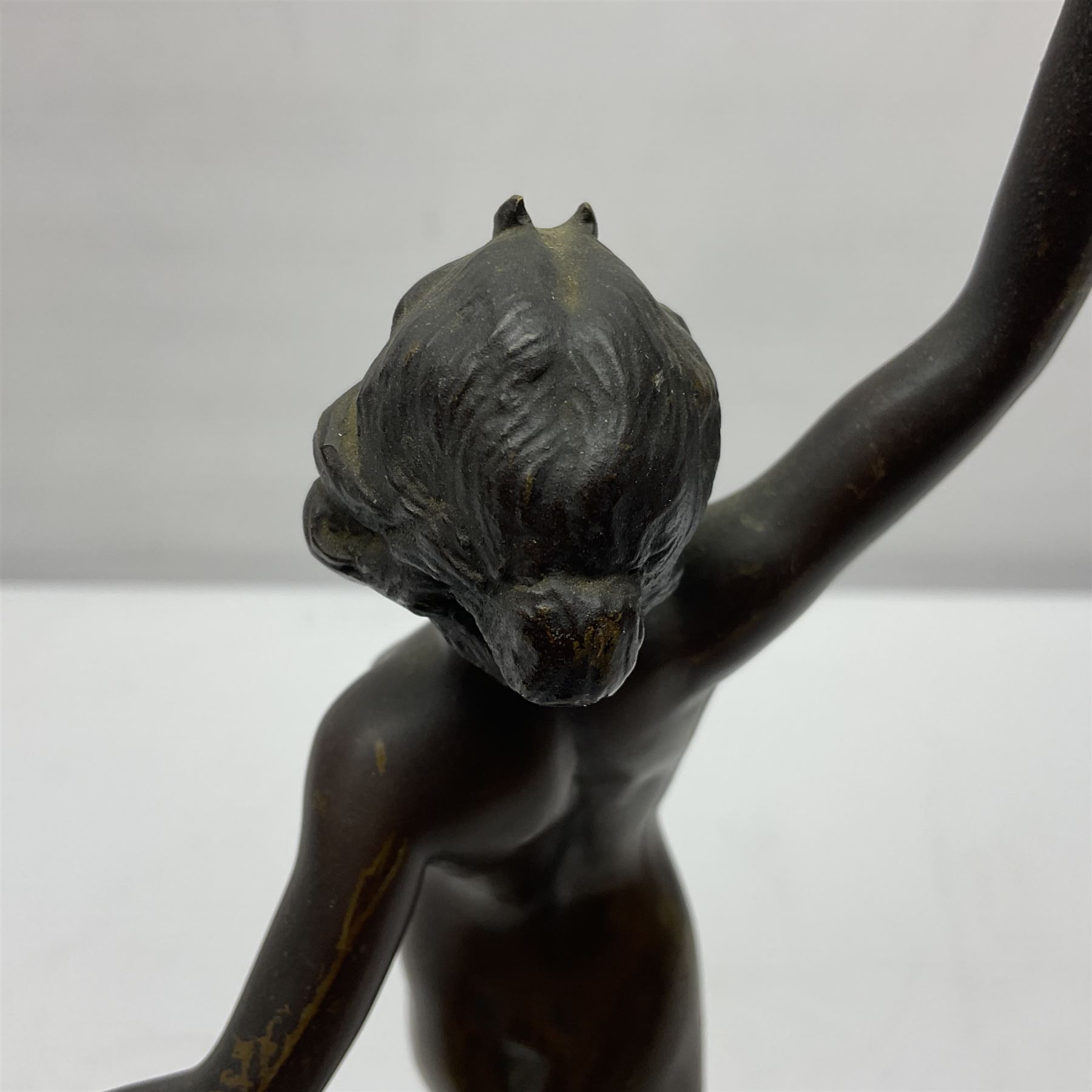 Bronze figure modelled as a nude woman with one arm raised a crescent moon upon her forehead, raised upon a circular stepped plinth, H36cm