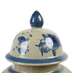 Pair of Chinese blue and white jars and covers, of baluster form, painted with fish and foliage H36cm