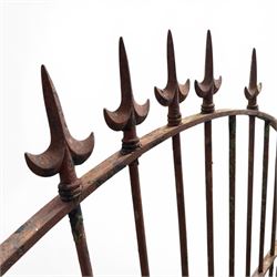 Georgian wrought iron single garden gate, pointed finial over strapwork cresting rail and arched profile with spearhead finials, the opposing side with scrollwork and hinged latch