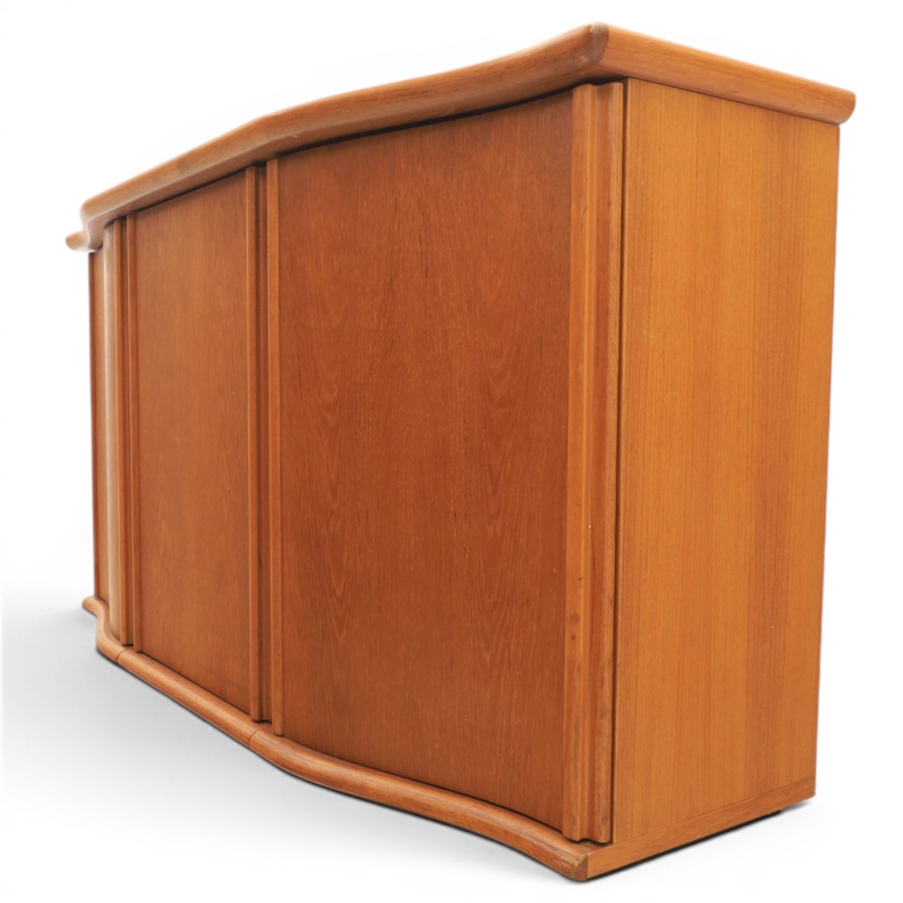 Skovby - model '400T' teak sideboard, shaped top above three cupboard doors with recessed handles, fitted with shelving and drawers