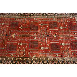Anatolian crimson ground tribal rug, the field decorated with repeating geometric tree of life motifs with figural designs, the indigo guard band with stylised palmettes