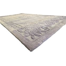 Chinese wool rug, purple ground with tonal floral and foliate pattern, central medallion of stylised flowers, the corners with large rosettes, framed by broad border of scrolling floral and leafy motifs 