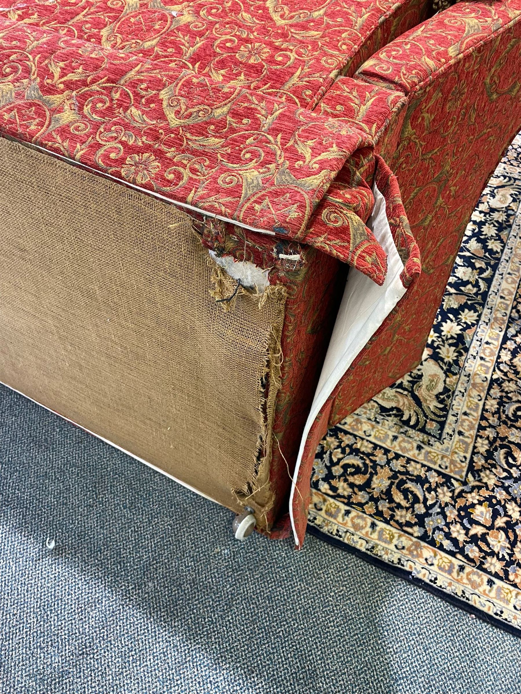 Large Knole design hardwood-framed three-seat drop-arm sofa, upholstered in crimson fabric decorated with trailing acanthus leaves and shields, together with scatter cushions 