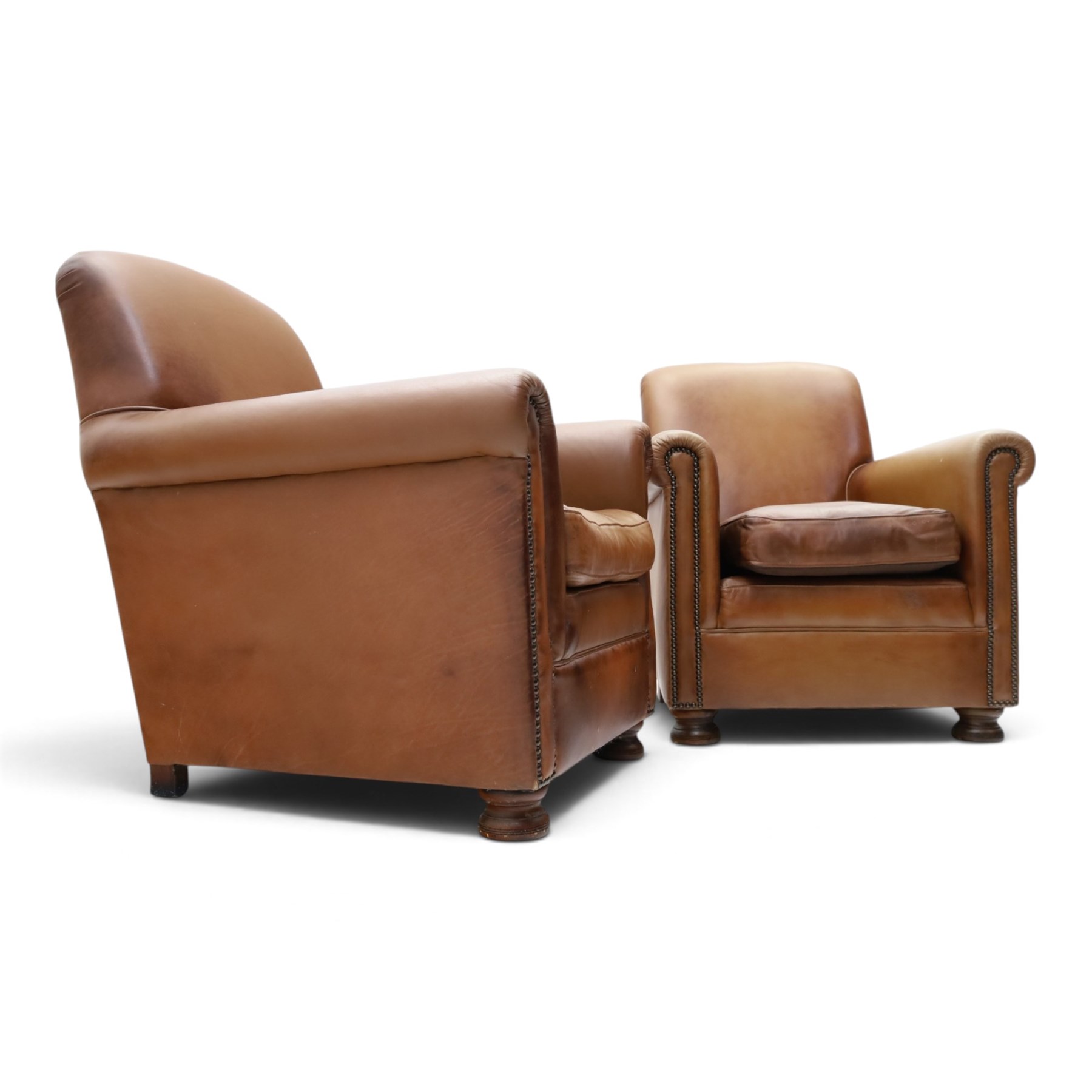 Pair of brown faux leather tub armchairs, scrolled arms with studded detail, turned front feet