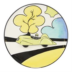Lorna Bailey prototype charger, decorated with a race car in relief within bright stylised landscape, signed verso, D34.5cm