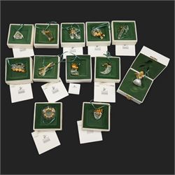 Twelve Swarovski crystal 'Christmas' and 'Crystal' Memories ornaments, comprising Moon, Sun, Boot, Candy Cane, Christmas Wreath, Pinecone and Holly etc, boxed and with sleeves (12)