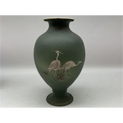 20th century Japanese vase, of pronounced baluster form, with waisted neck and spreading circular foot with beaded detail, the green matt body hand painted with cranes amidst grasses, H31cm