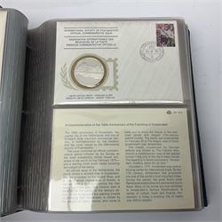 Thirty-one 'International Society of Postmasters Official Commemorative Issues' sterling silver proof medallic covers dating from 1975 to1977, housed in the official folder and a 'Commemorating The Bicentennial Of The United States Of America' sterling silver proof medallic first day cover in blue wallet