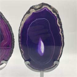 Pair of purple agate slices, polished with rough edges, raised upon silvered metal stands, H20cm