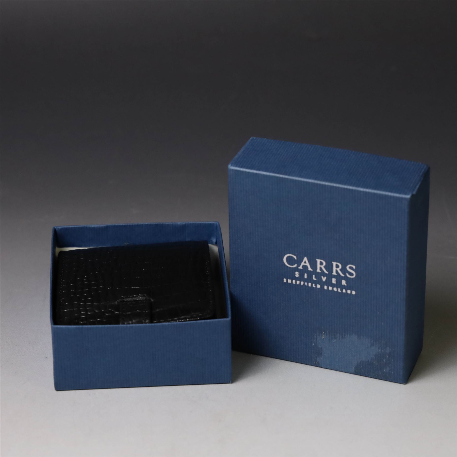 Silver mounted glass decanter, boxed with wooden plinth, together with a silver pepper grinder and a silver mounted Carrs desk clock, all hallmarked