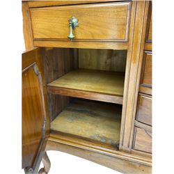 Late Victorian walnut mirror back sideboard or dresser, the raised back fitted with two curved and lead glazed cabinets, central arched bevelled mirror, the sideboard with break bowfront, fitted with six drawers and two cupboards, the cupboard doors panelled and carved with scrolls, shell and plant motifs, shaped apron with cabriole feet
