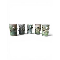 Set of five weathered terracotta strawberry pots, circular form with ribbed top