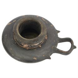 Etruscan terracotta oil lamp, with black glaze, flat loop handle and laurel leaf border, the opening with later turned wooden collar, signed to base 'repaired by one James Naysmith 1887', H7cm 
