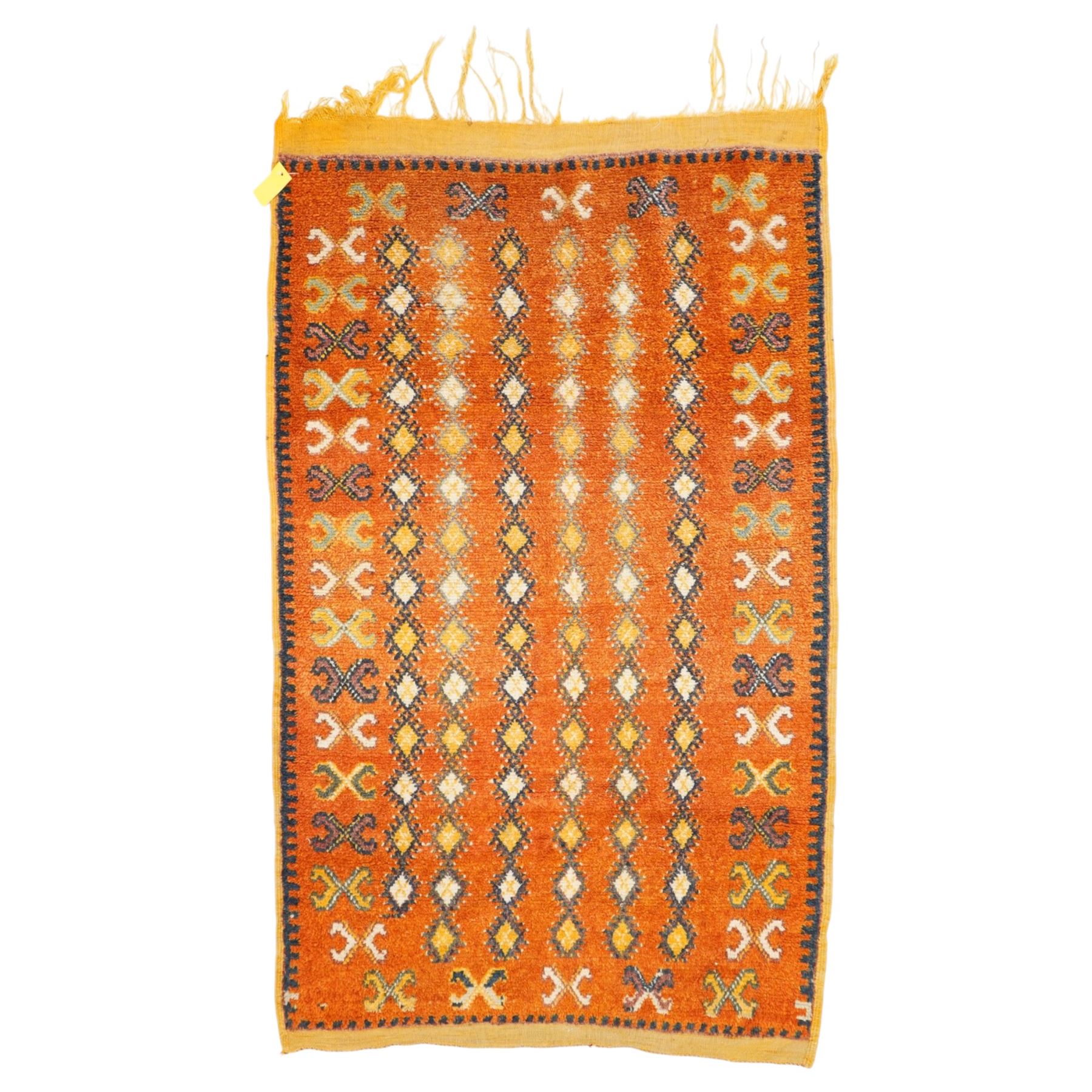 North Persian tribal rug, an orange field and six rows of lozenges, with a border of ram's horn motifs