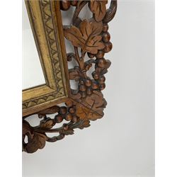 20th century rectangular wall mirror in walnut frame carved and pierced with foliage and berry decoration, carved and gilt slip