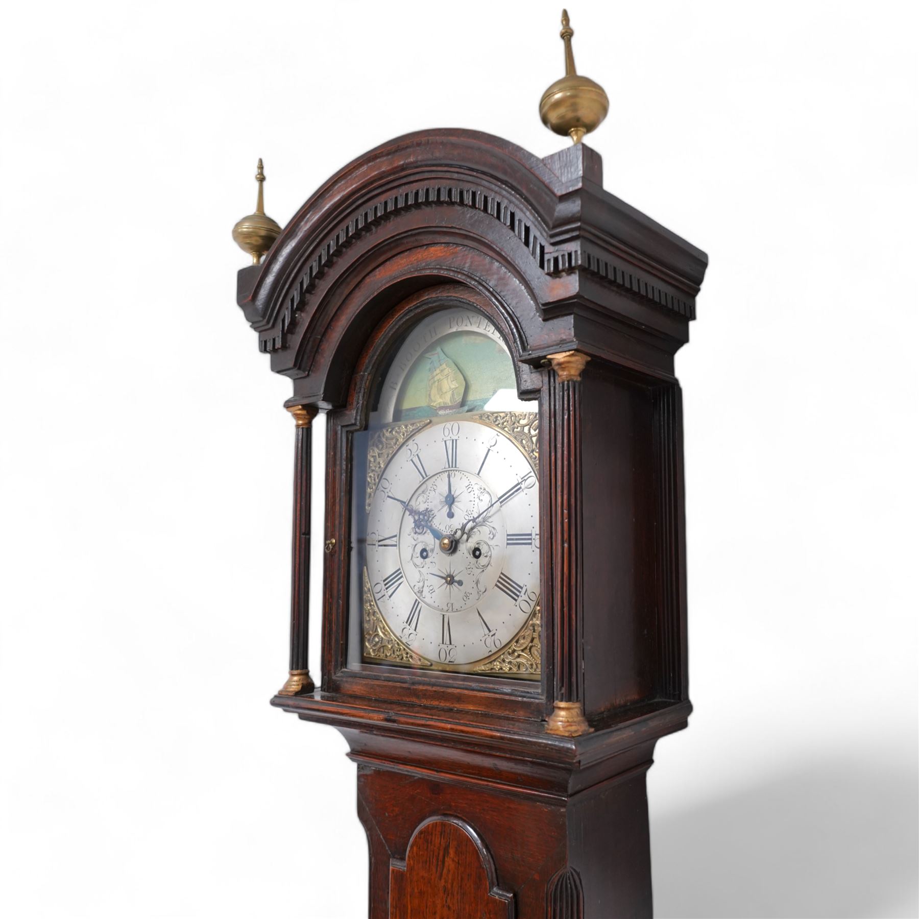 Benjamin Booth of Pontefract - 8-day oak longcase clock c1790. with a stepped broken arched pediment, deep cornice with dog tooth moulding and two brass finials, break arch hood door with flanking reeded pilasters and gesso capitals, trunk with canted corners and a long break arch topped door, on a rectangular plinth with applied skirting, brass dial with rocking ship automata and makers name to to the arch, with bordered cast spandrels and an silvered engraved dial centre, chapter with Roman numerals and five minute Arabic's, matching steel hands , calendar and seconds dials, movement pinned to a rack striking movement with a recoil anchor escapement. With weights, pendulum and key.
Benjamin Booth is recorded as being apprenticed to John Booth of Huddersfield in 1760 and working in Pontefract c1766 until his death in 1806. 