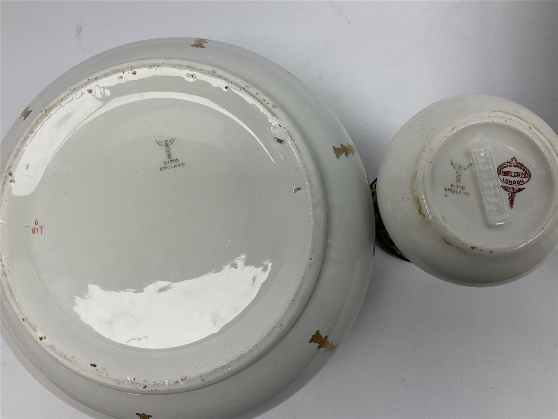 Early 20th century Bishop and Stonier four piece toilet set, comprising washbowl, wash jug, toothbrush pot, and chamber pot, each  decorated with deep blue band and husk swags and festoons in gilt, with printed Caduceus Bisto marks beneath and printed retailers mark 'Manufactured for Harrods Limited London', wash bowl D43cm, wash jug H31.5cm