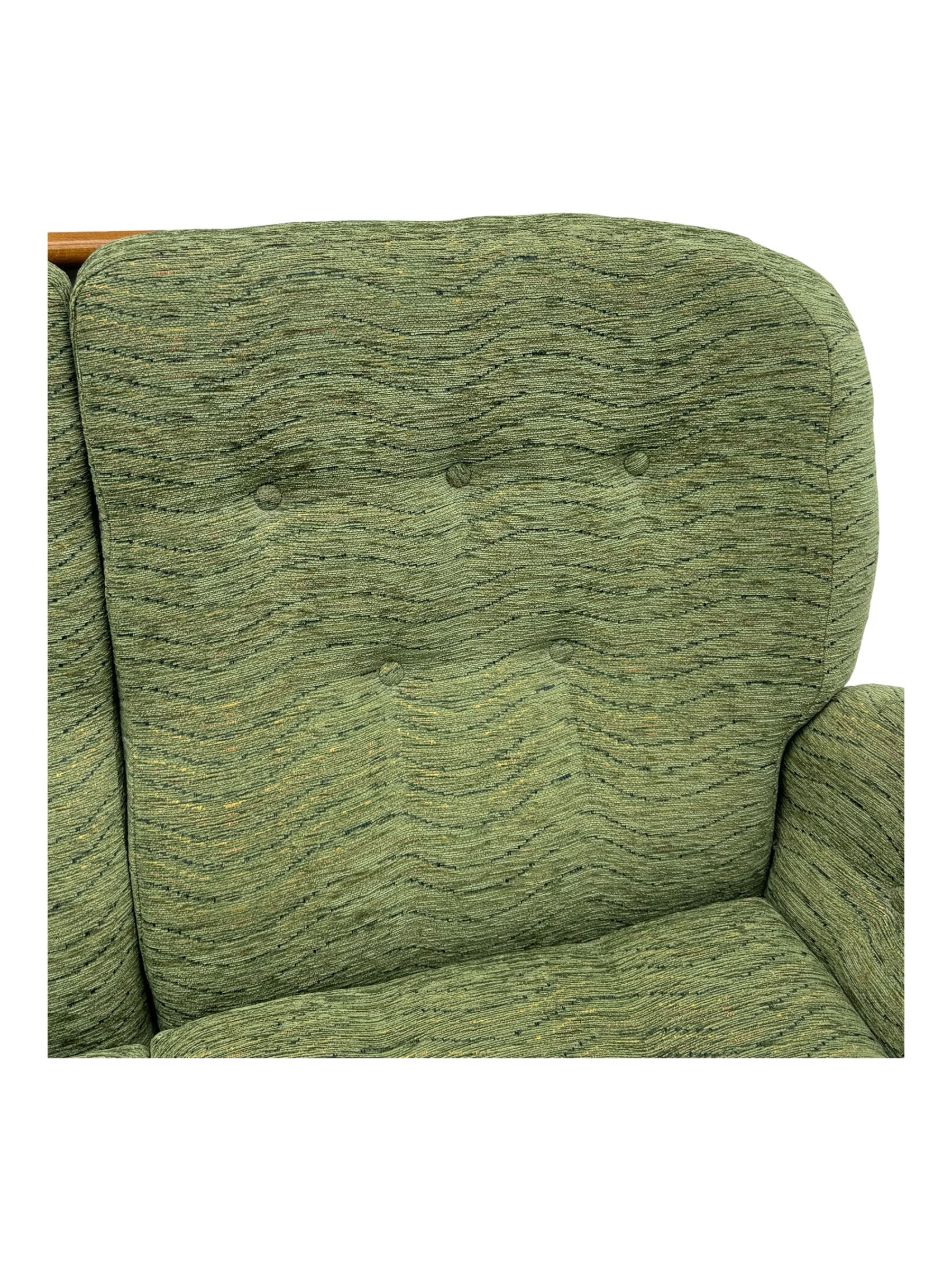 Ercol - mid-20th century three-piece suite, comprising two-seater sofa, upholstered in green fabric with teak frame, on splayed supports with stretcher (W142cm, D95cm, H87cm); with matching pair of armchairs (W82cm, D95cm, H87cm)