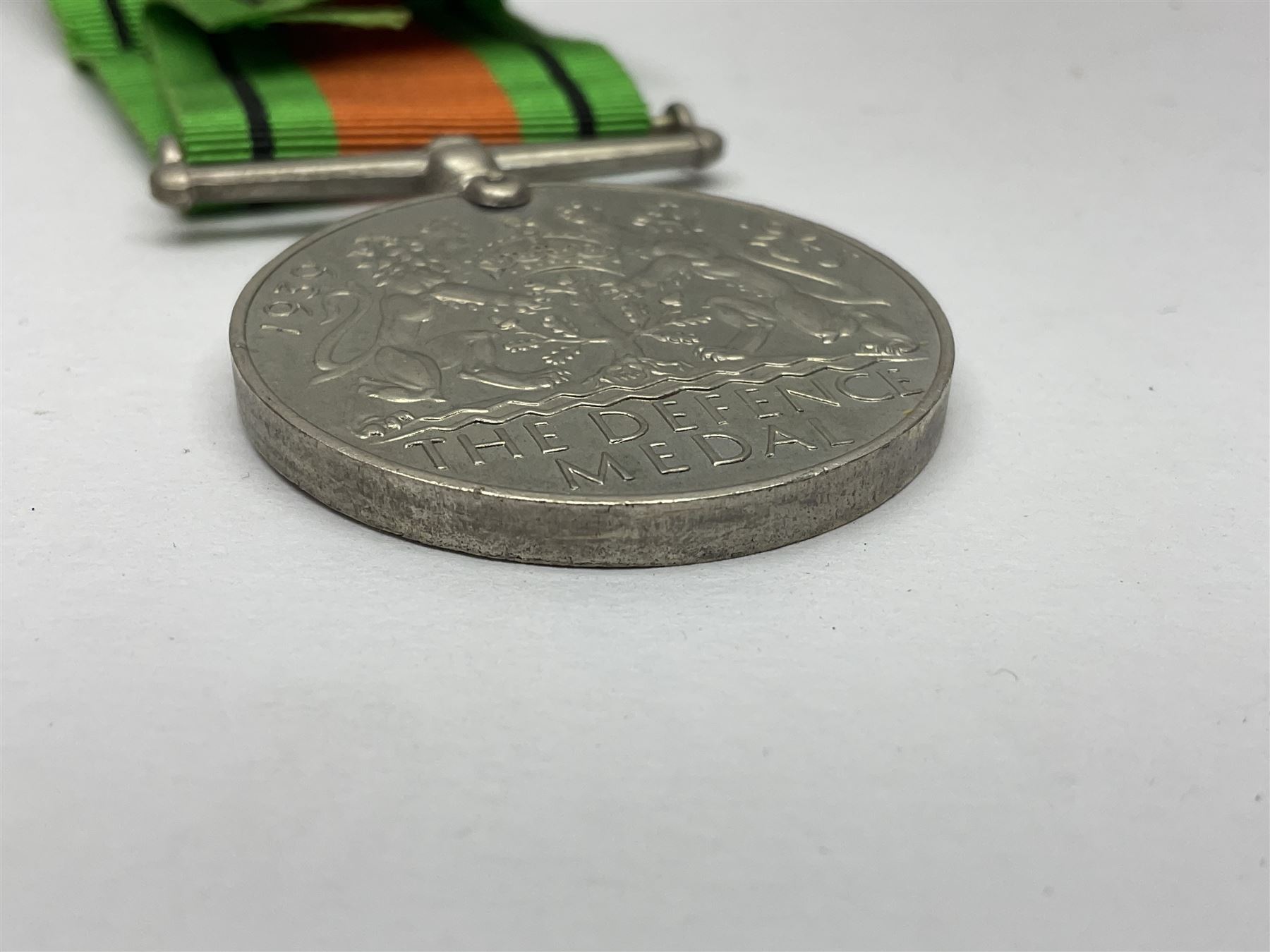 Twelve WW2 medals comprising four 1939-1945 war medals, four Defence medals, three 1939-1945 Stars and Africa Star; all with ribbons; some as groups in two issue boxes with slips