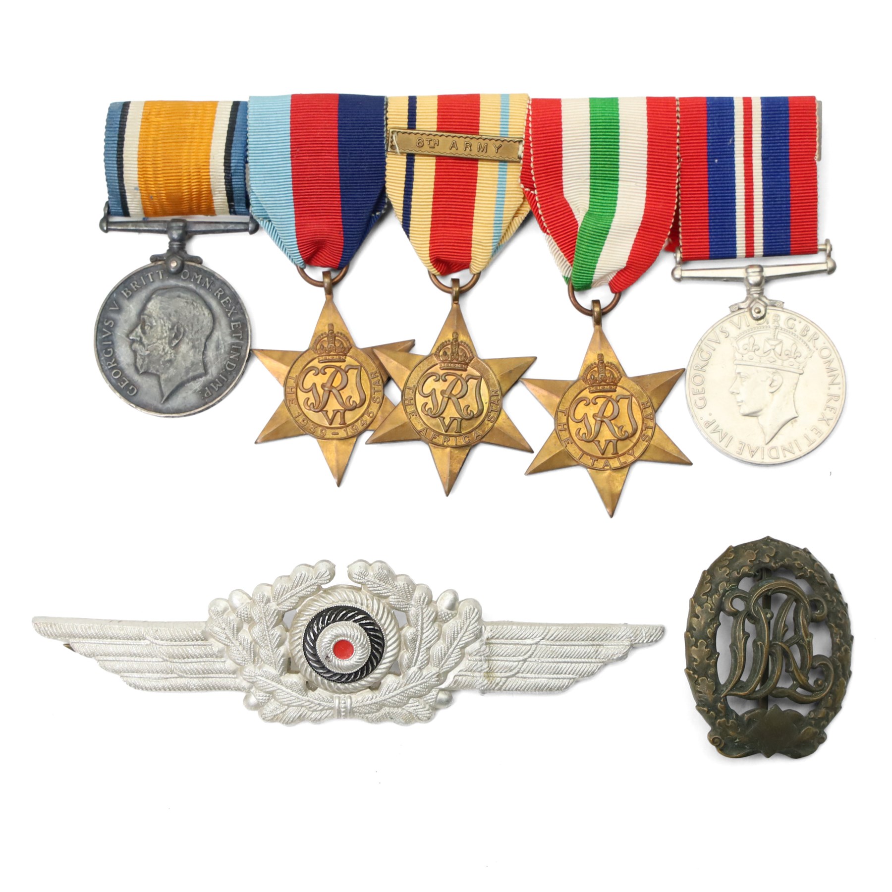 Five medals, possibly a family group comprising WWI War Medal to 9220 Pte H L Skillicorn, Machine Gun Corps and four WWII medals comprising War Medal, Africa Star with 8th Army bar, 1939-1945 Star and Italy Star, a German cap badge and one other German badge