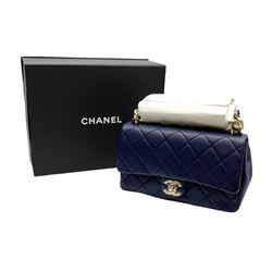 Chanel quilted flap bag of lambskin leather with light gold tone hardware,  front flap with signature CC turnlock closure, back pocket, and adjustable interwoven light gold tone chain link and navy leather shoulder strap, accompanied by Chanel box, Chanel dustbag, felt, receipt, carebook and Chanel bag