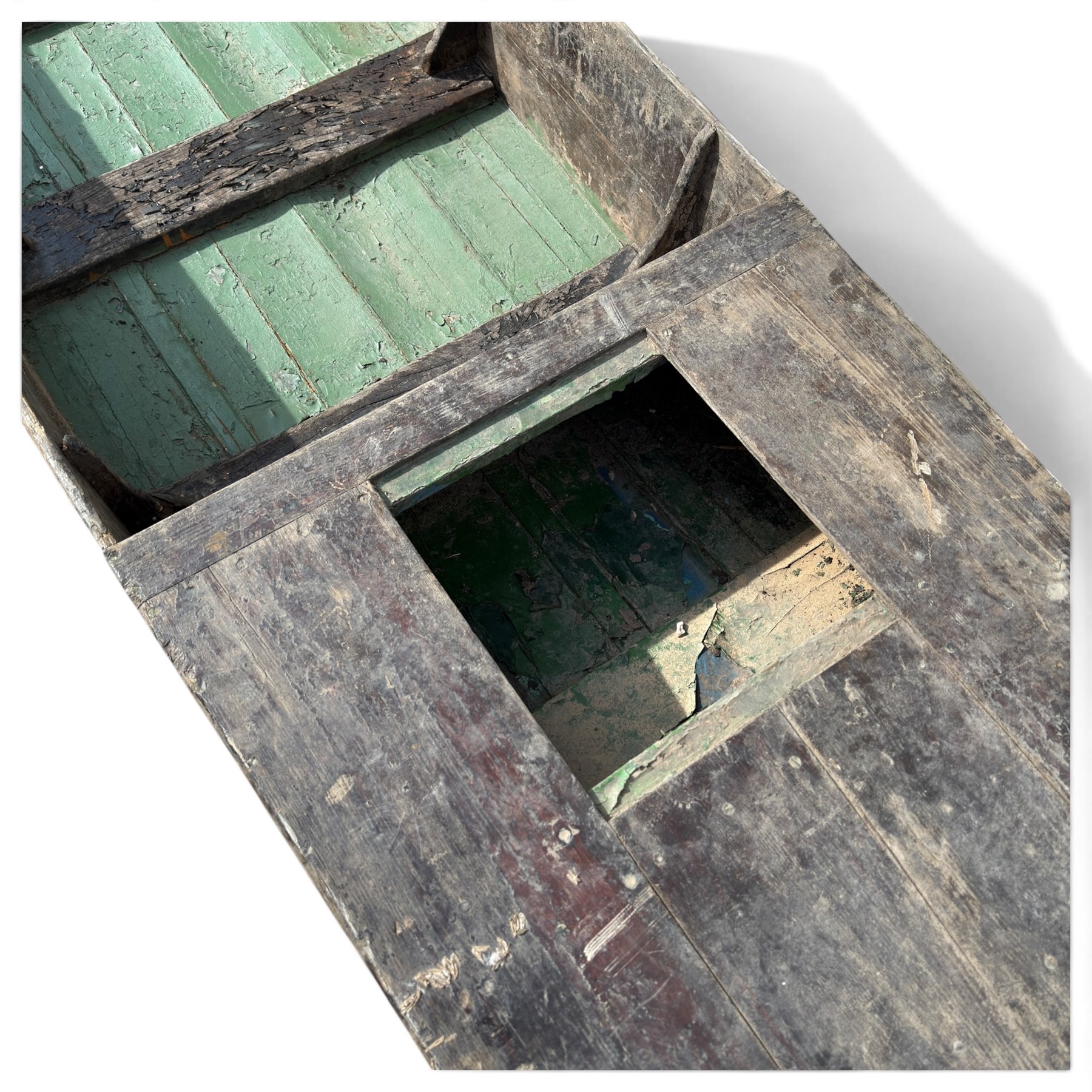 Large early 20th century plank-built wooden river punt, the long tapering hull with enclosed fore and aft decks, open green-painted ribbed interior, together with two paddles