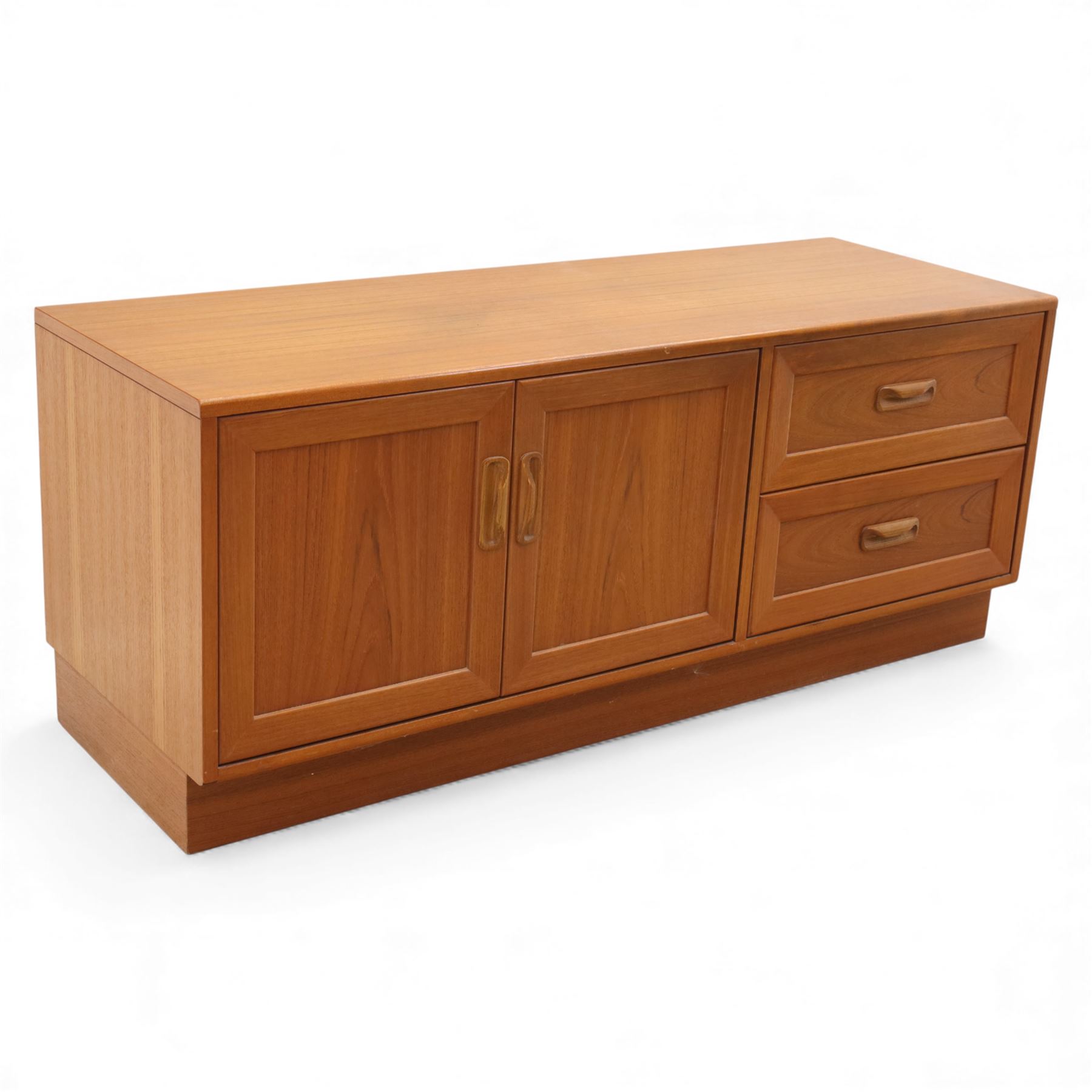 G Plan - 'Fresco' teak side unit, rectangular top above twin cupboard doors and two drawers, drawers fitted with cassette tape storage and a fall front drawer, raised on a plinth base