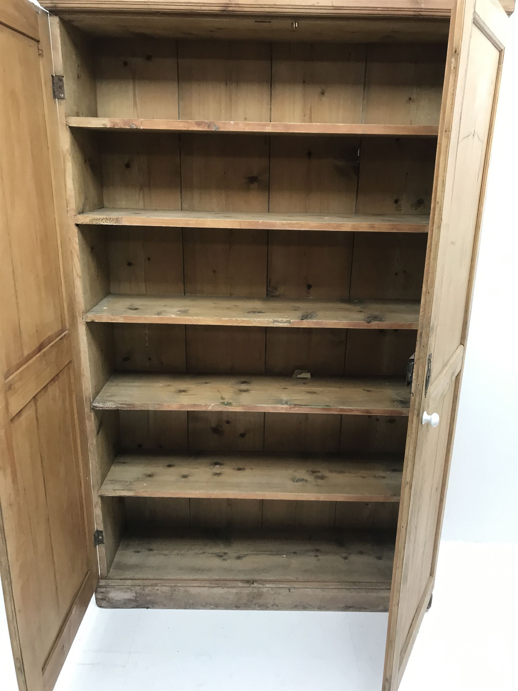 19th century housekeeping cupboard, projecting cornice above two panelled doors, plinth base