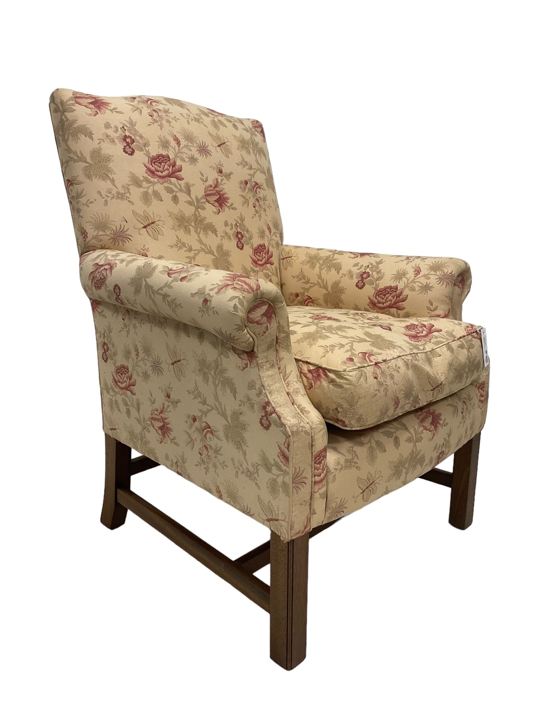 Peter Dudgeon - Georgian design mahogany framed armchair, shaped cresting rail over sprung back and seat flanked by rolled arms, upholstered in floral patterned fabric with matching seat cushion, on square supports joined by stretchers
Provenance: From the Estate of the late Dowager Lady St Oswald