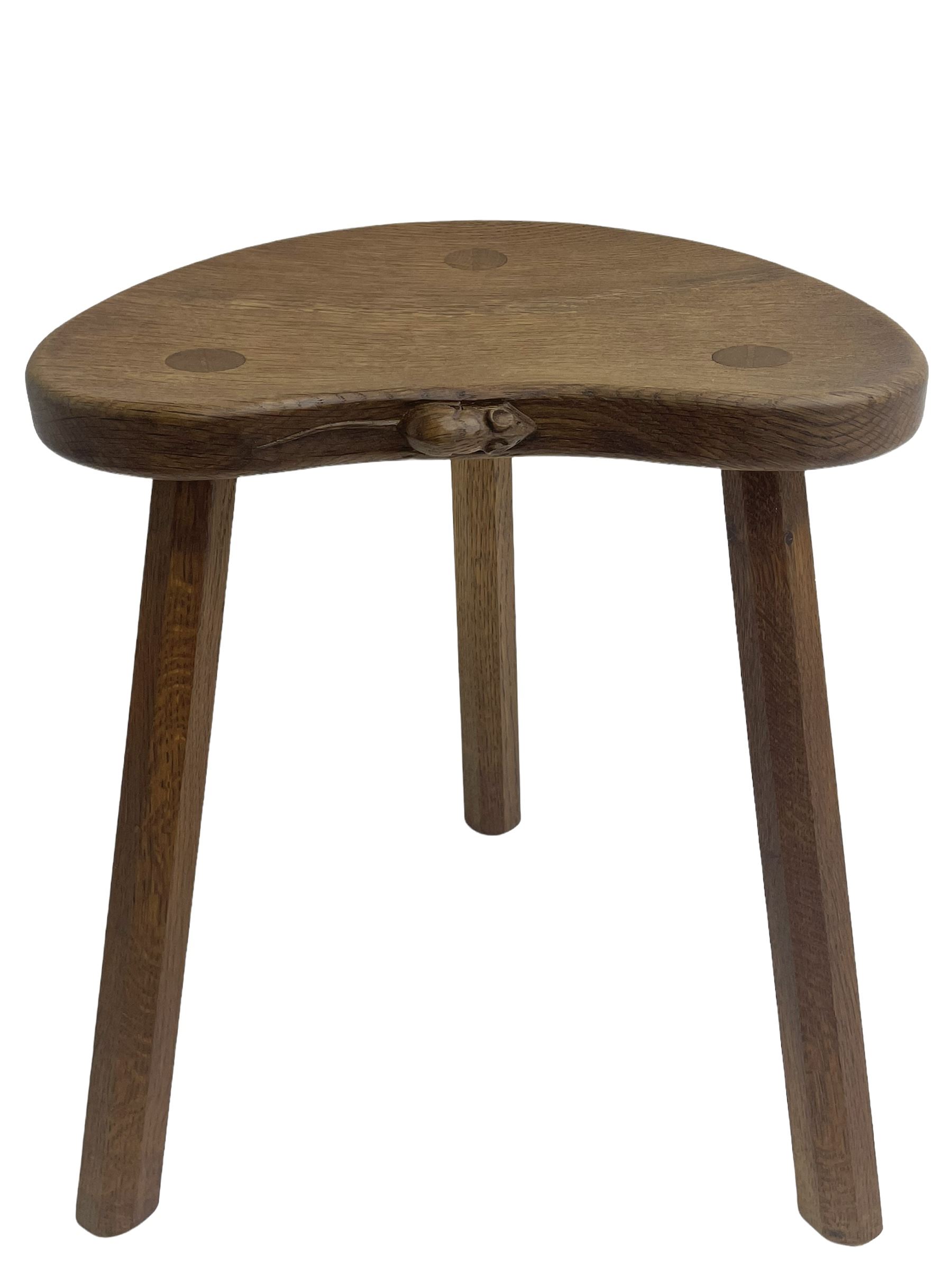 'Mouseman' oak three-legged stool, kidney shaped dished seat carved with mouse signature to edge, by Robert Thomas of Kilburn