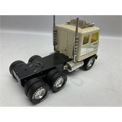 American Nylint large scale tin-plate car transporter L59cm carrying a Testor Toys plastic car; Tonka tin-plate mobile crane; boxed Sarony Cigarettes tin-plate roulette game with rules; and Japanese style tin-plate box, the lid inset with a revolving poker dice game (4)