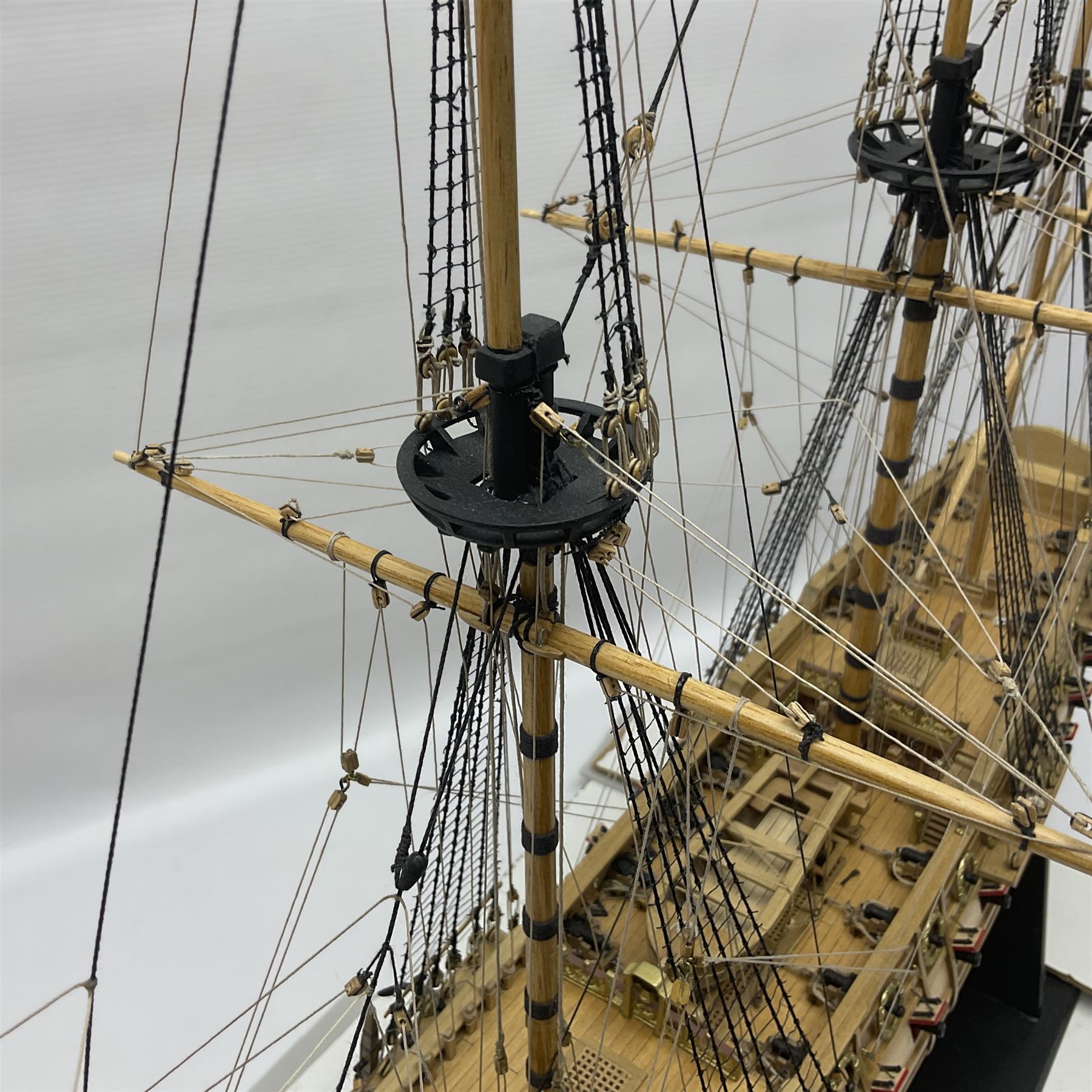 Wooden kit built model of HMS Neptune, 1:90 scale, with detailed rigging to three masts and a row of cannons to either side, upon ebonised wooden base, including stand H71cm