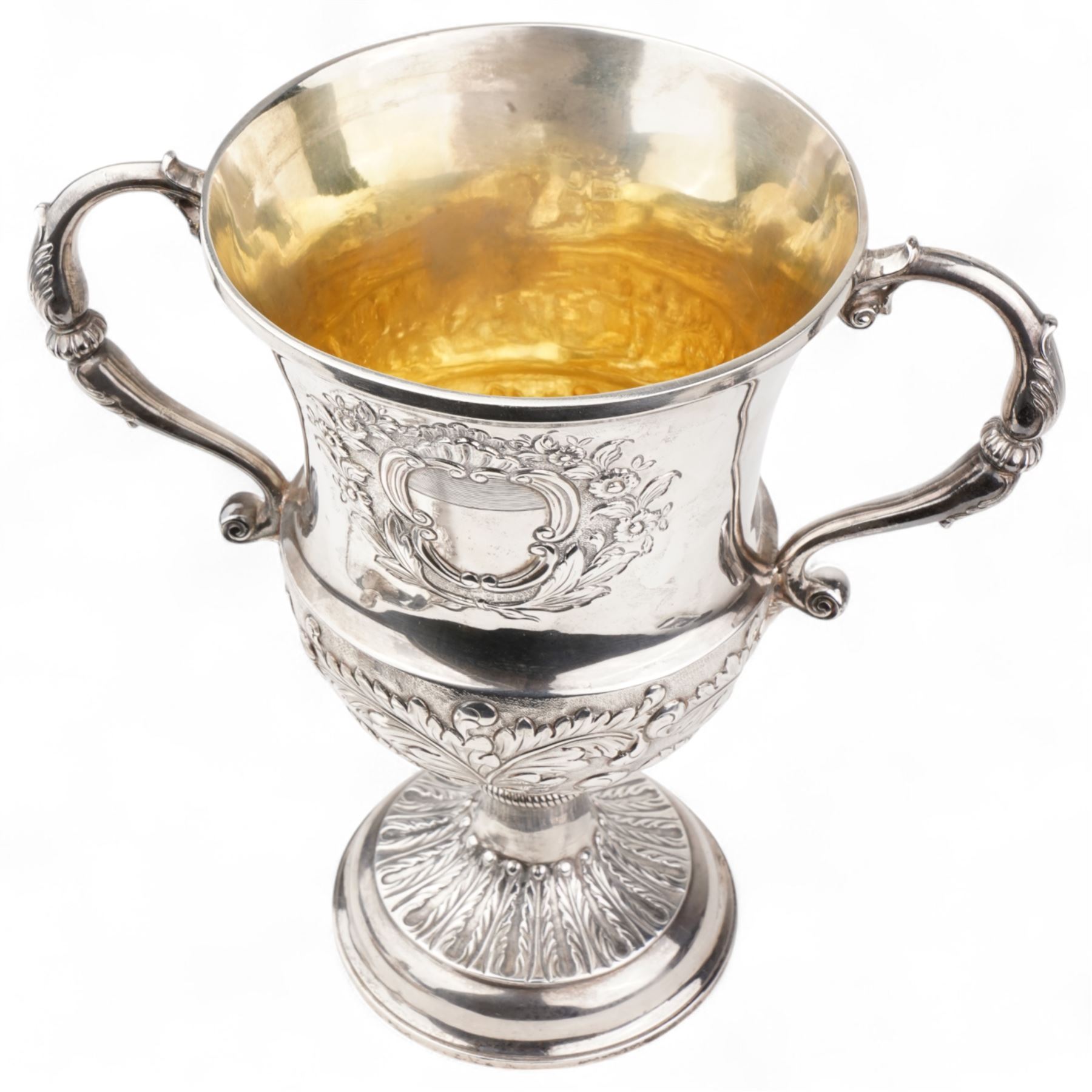 George III silver two handled campana shape cup and cover with pineapple lift, the body with cartouche surrounded by flowers above leaves and scrolls on a pedestal foot with acanthus leaf decoration H29cm London 1764, makers marks rubbed