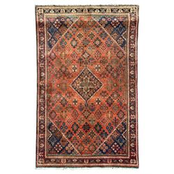 Persian Joshaghan rust ground rug, stepped lozenge medallion surrounded by repeating foliate lozenge motifs, the border decorated with stylised plant motifs, within geometric guard stripes
