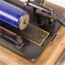 Early 20th century Edison Standard phonograph, in oak case, serial number S179930, together with a large brass phonograph horn and a collection of wax cylinders