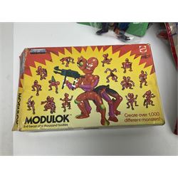 Thirty-one Masters of the Universe He-Man figures re-bagged on original backing cards;  two others lacking backing cards; boxed Modulok figure; bag of weapons and accessories; Roton, two horses and two battle cats; 1986 & 1987 Annuals; Ladybird and other story books; Panini sticker album; instructions etc